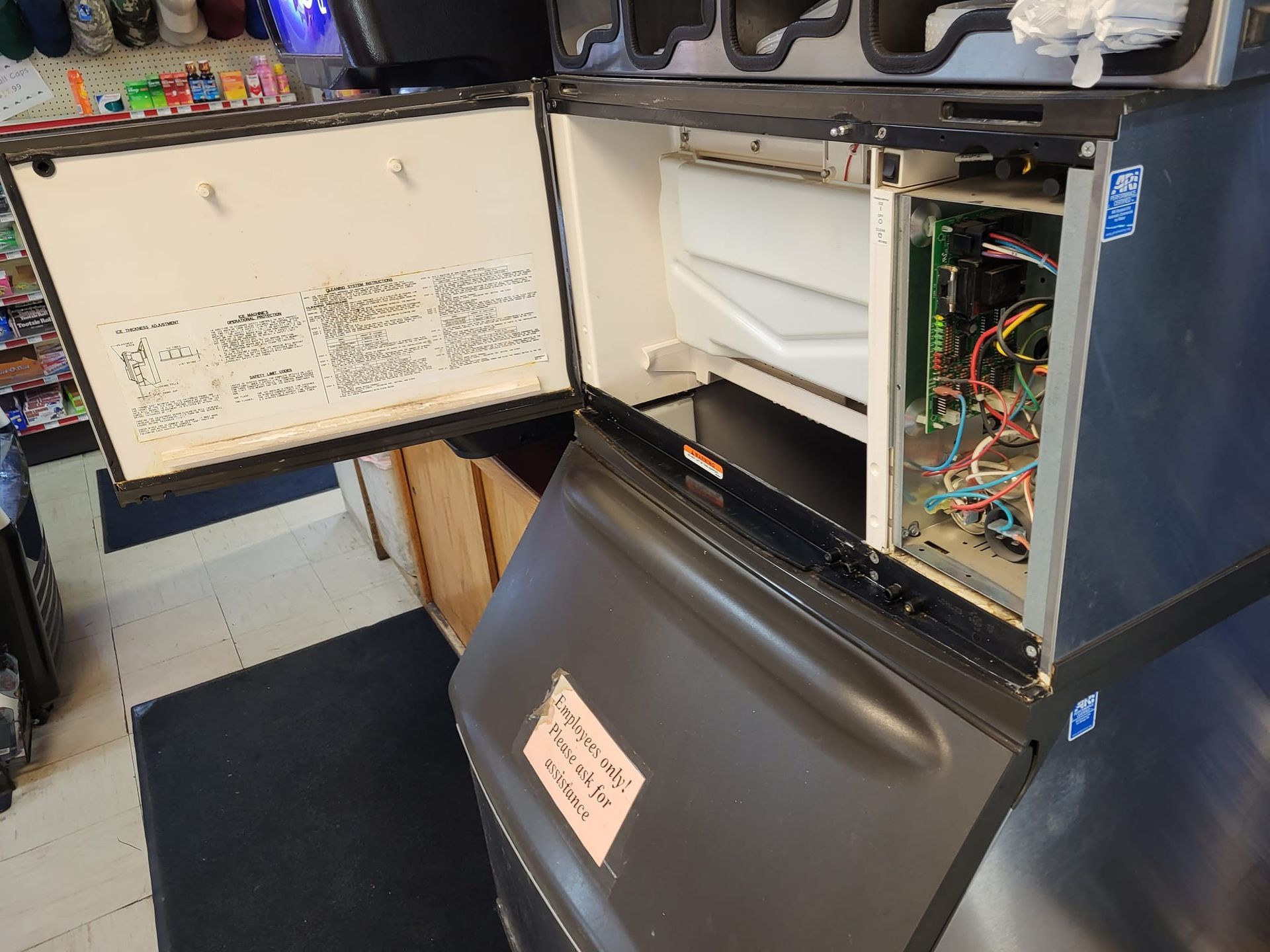 A refrigerator with the door open is sitting on top of another refrigerator.