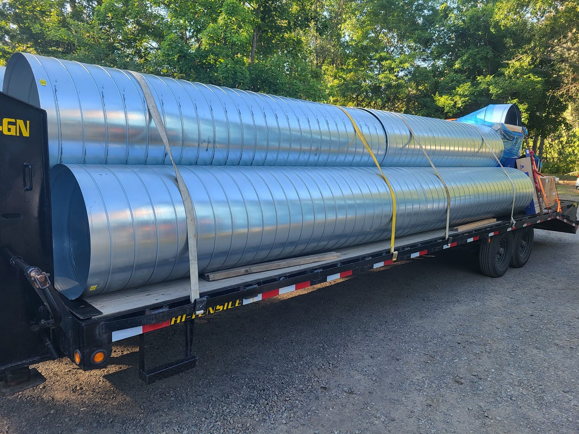 A trailer with a bunch of metal pipes on it.