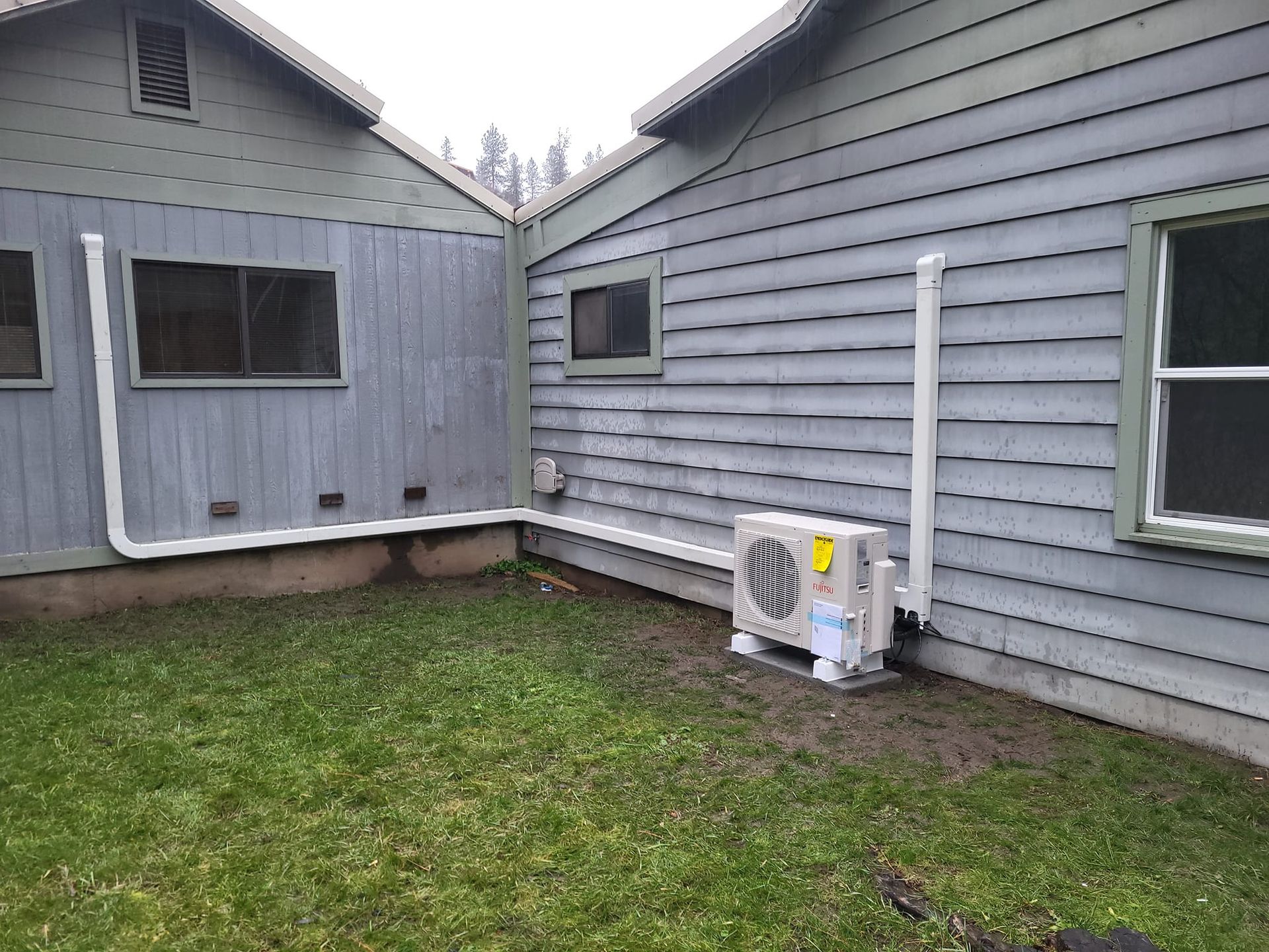 A house with a large air conditioner on the side of it.