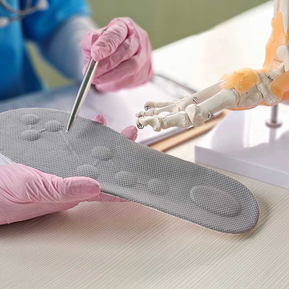 Doctor installing a custom orthopedic insole