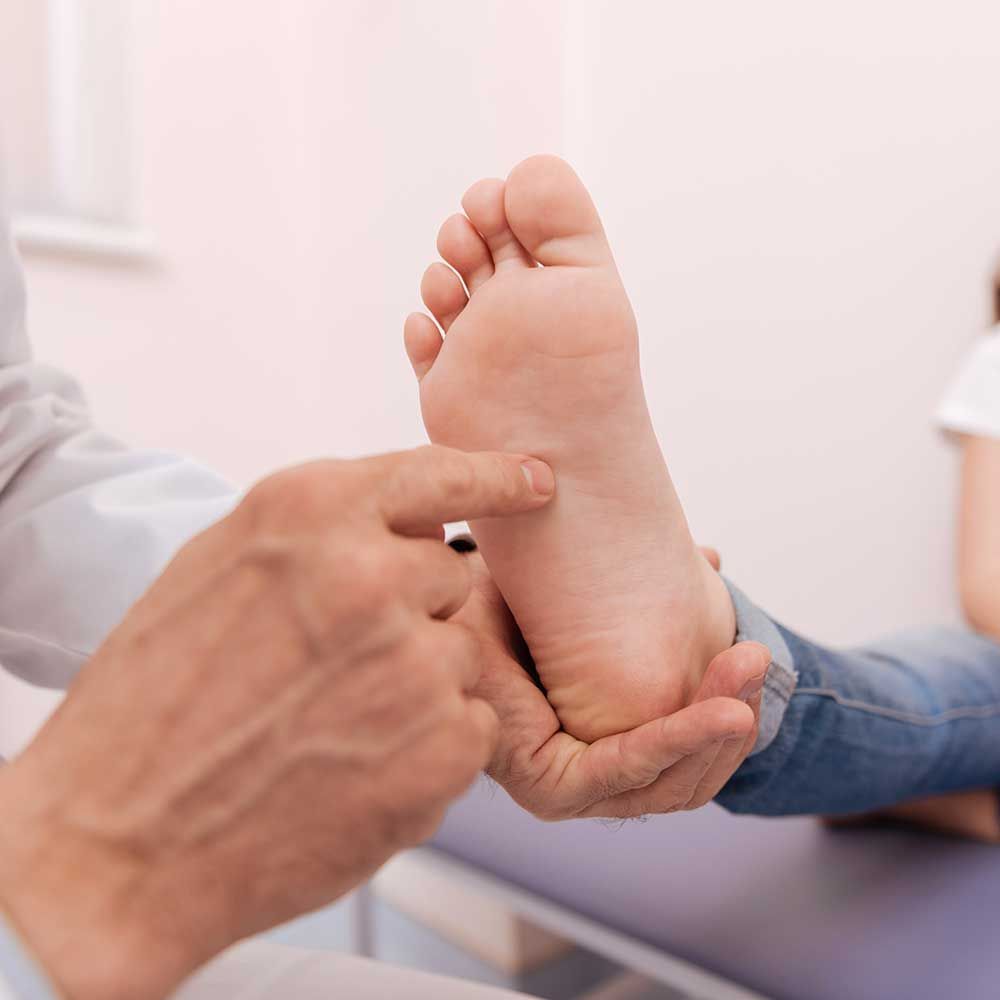 Doctor running a checkup on child's foot