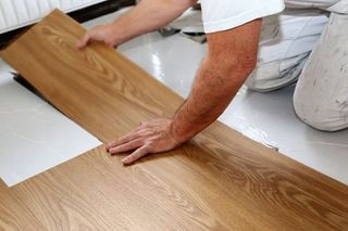 Laminate Wood Floor — Man Laying PVC-Floor in Zoarville, OH