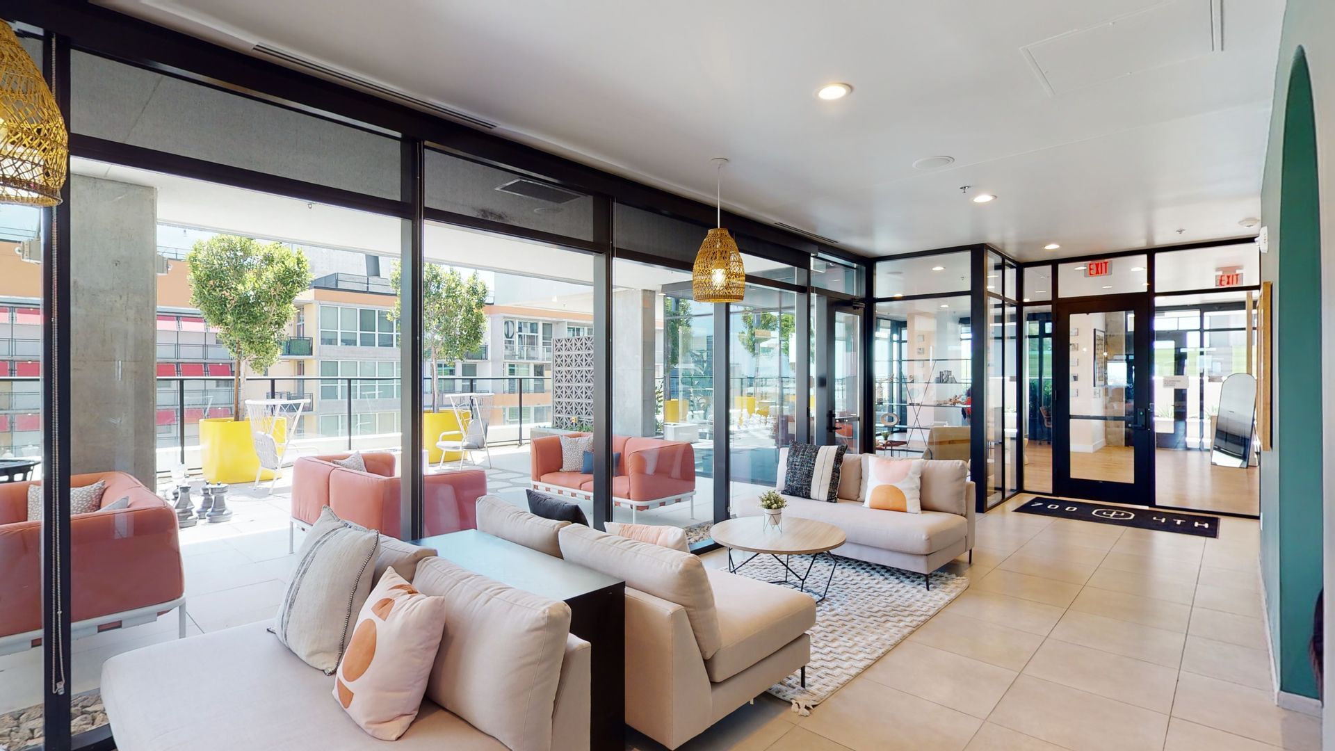 A living room with a lot of furniture and a lot of windows.