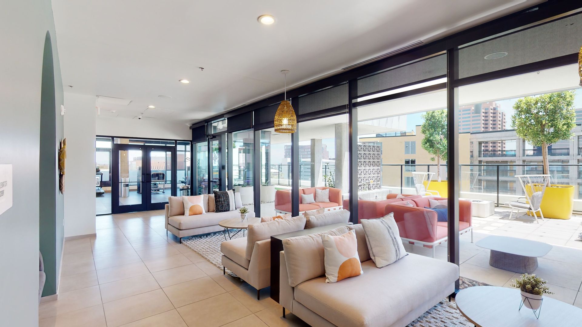 A living room with a lot of furniture and a balcony.