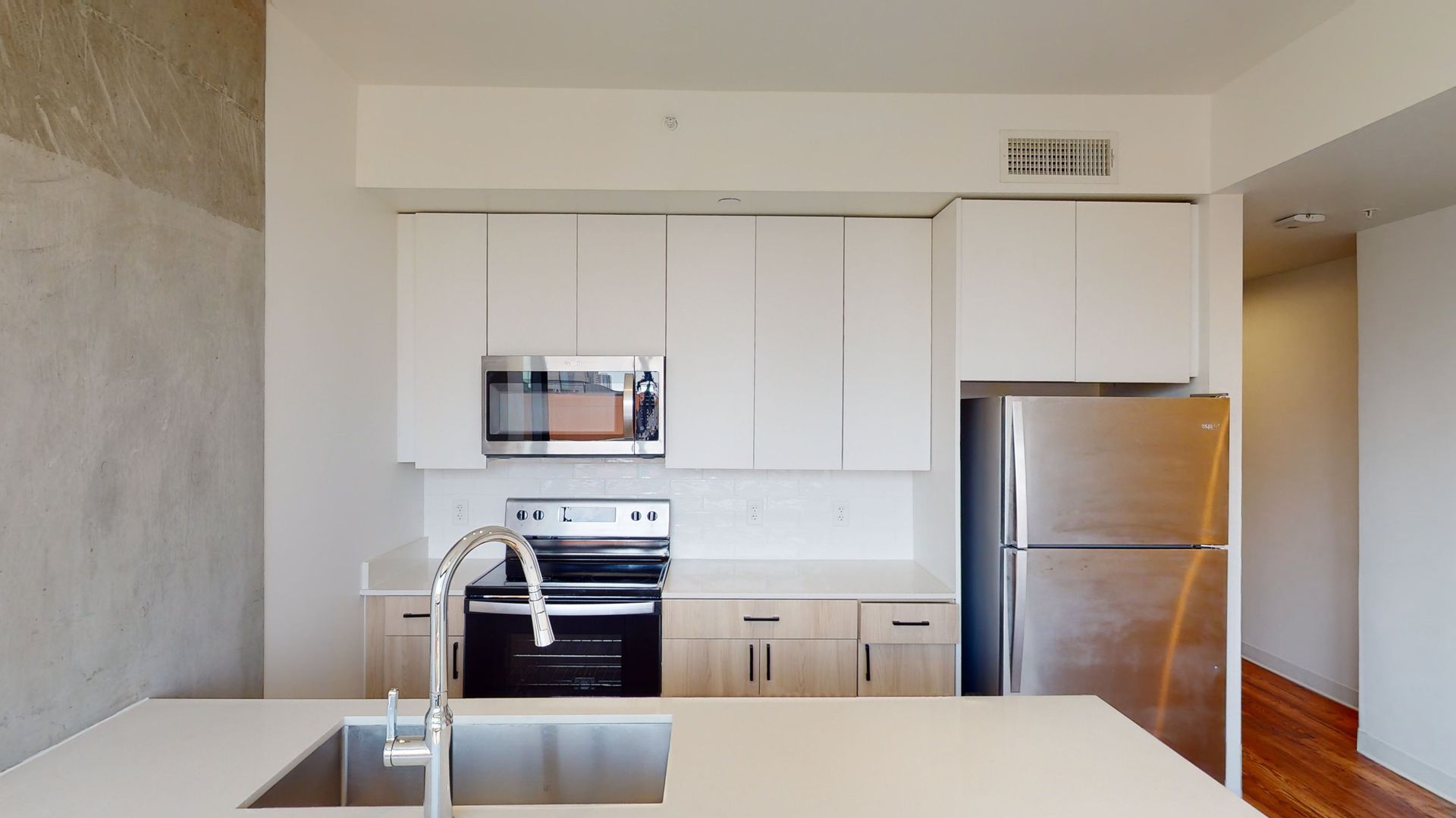 A kitchen with stainless steel appliances and white cabinets