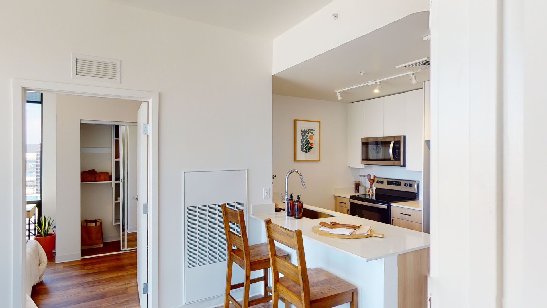 A 3d model of a kitchen and dining room in a house.
