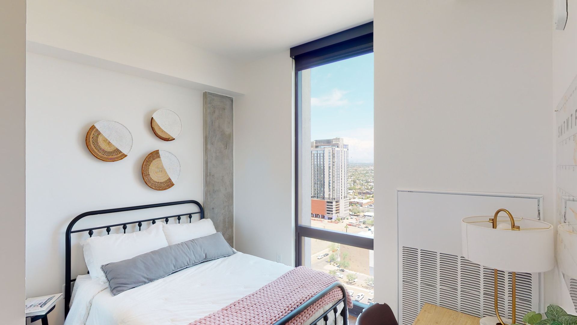 A bedroom with a large bed and a large window.