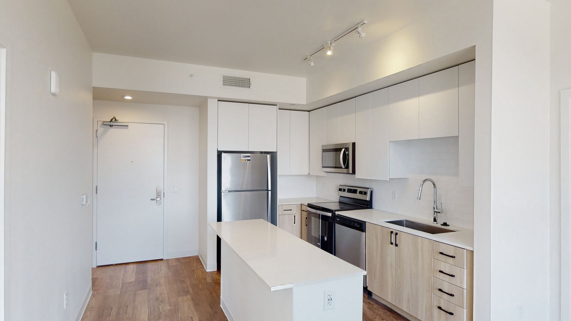 A kitchen with white cabinets and stainless steel appliances.
