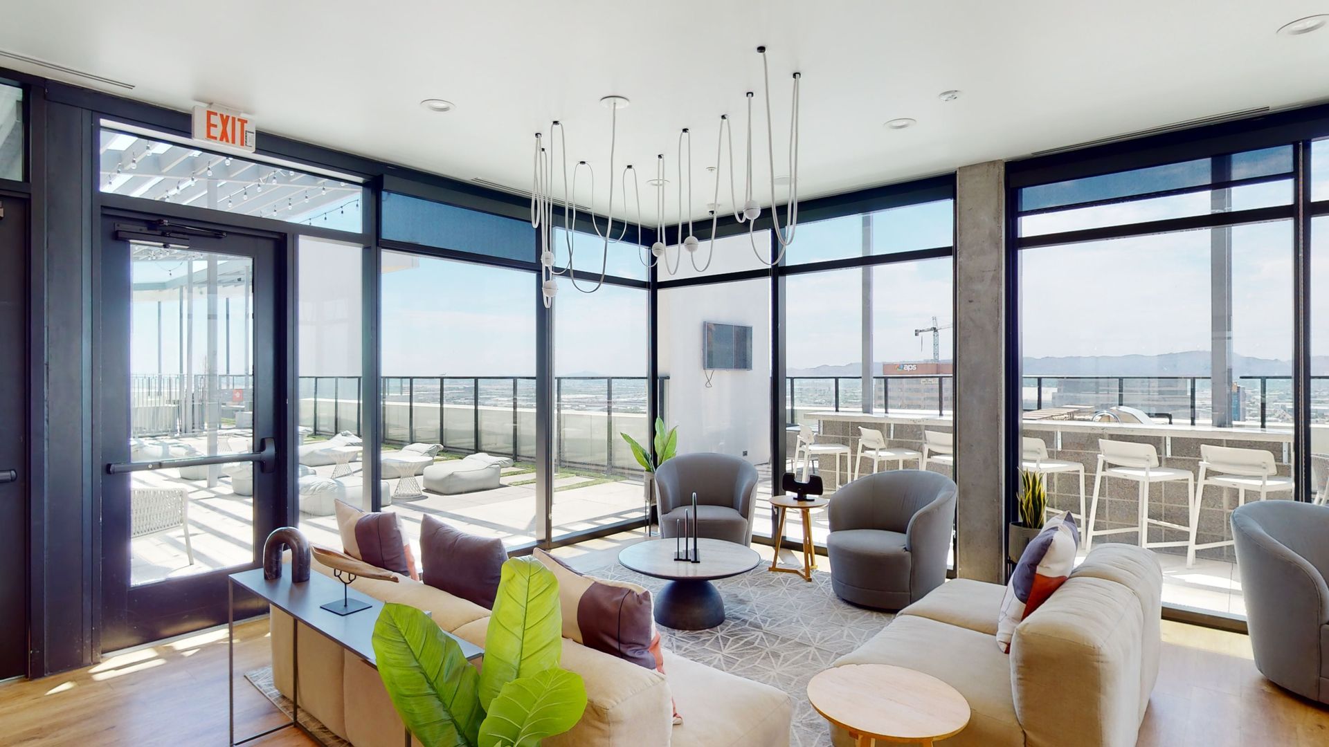 A living room with a lot of windows and furniture.