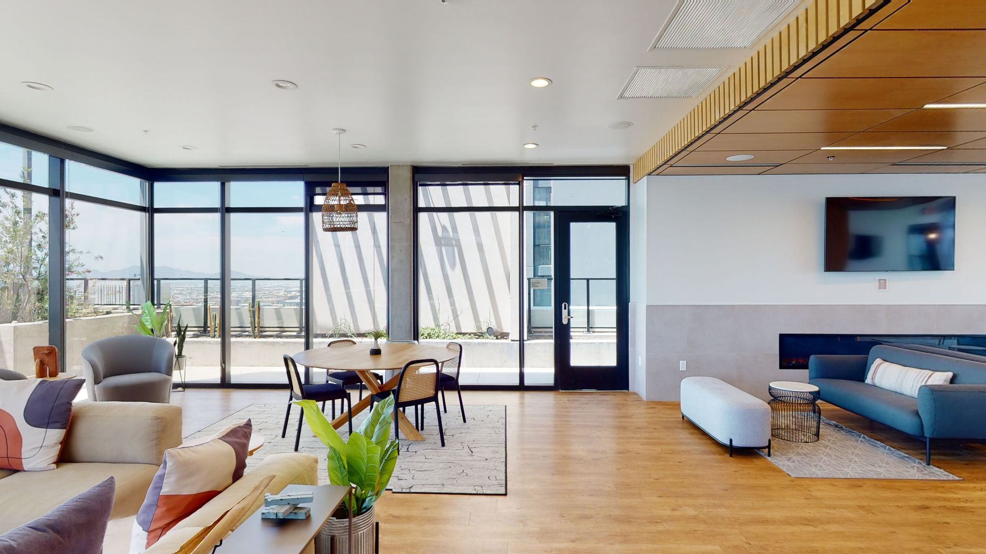 A living room with a couch , chairs , a table and a television.