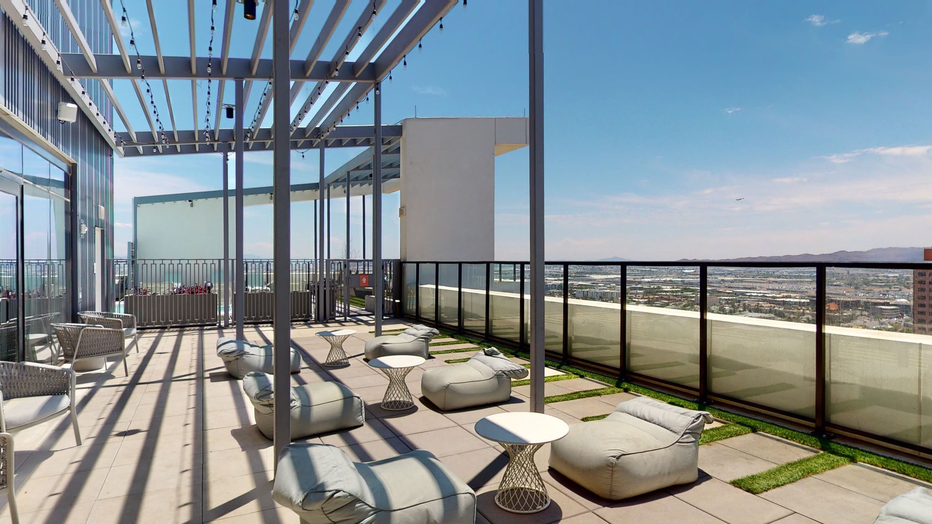 An artist 's impression of a rooftop terrace with a view of the city.