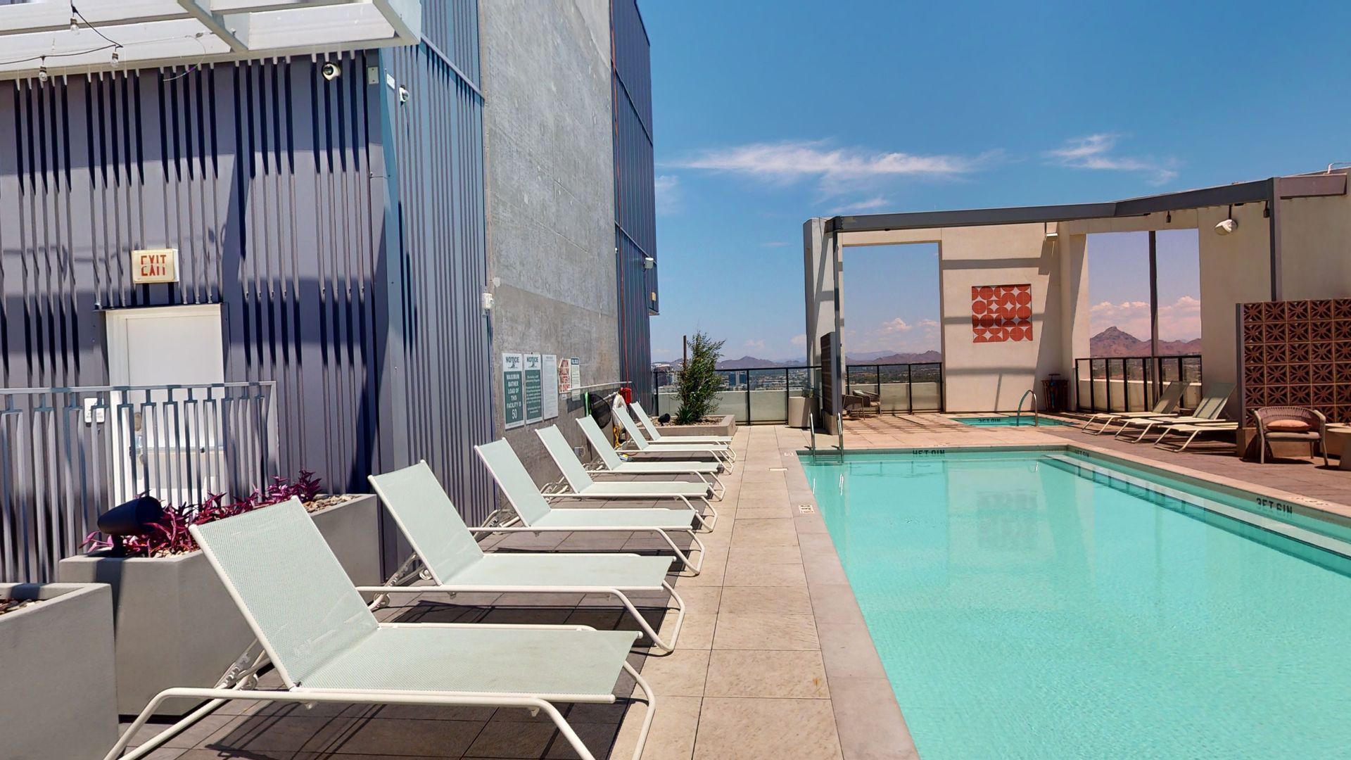 A swimming pool with a lot of chairs around it