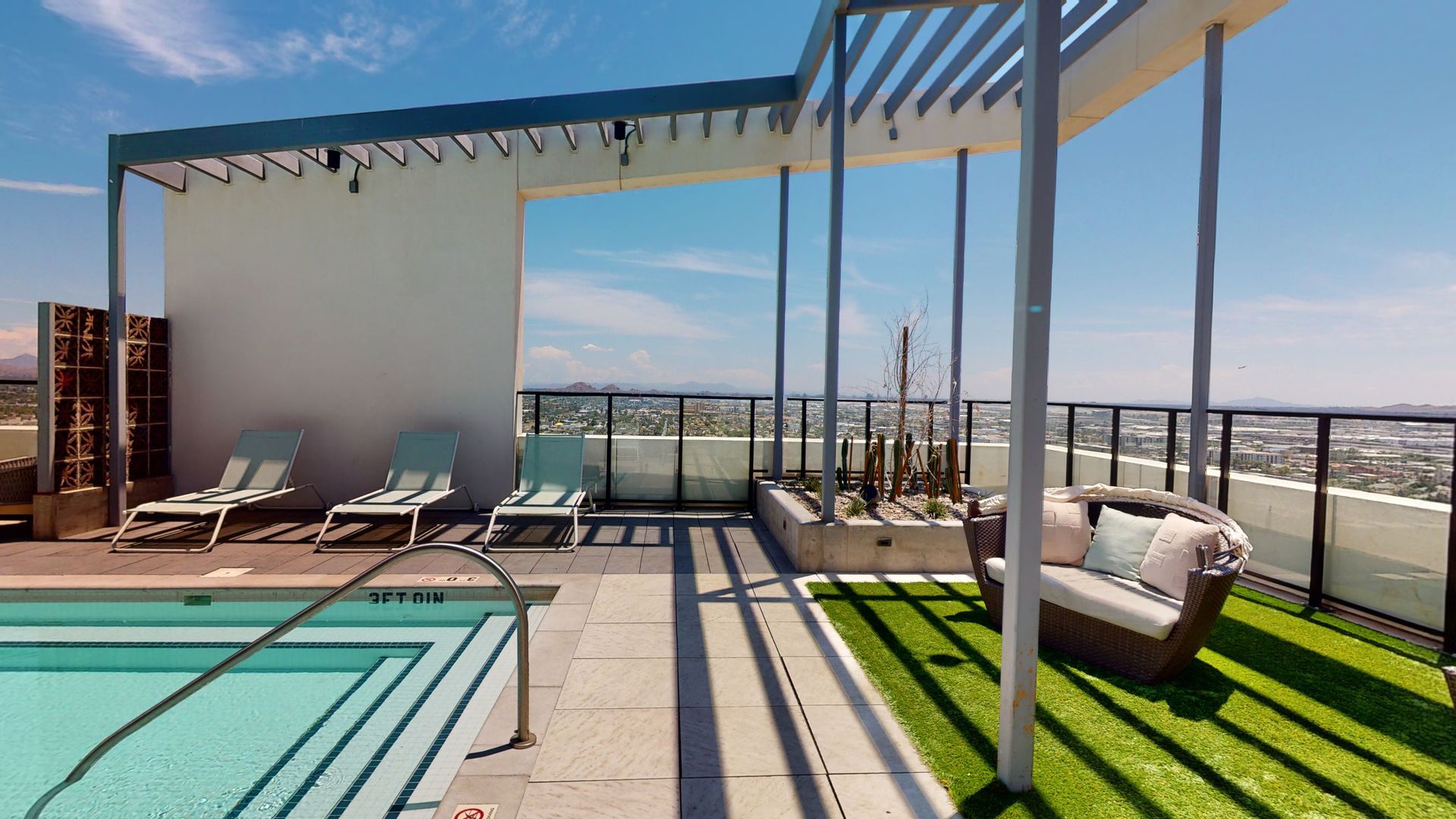 There is a swimming pool on the roof of a building.