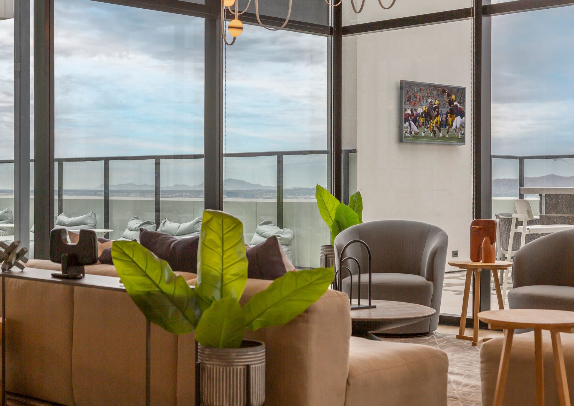 A living room filled with furniture and a large window with a view of the ocean.