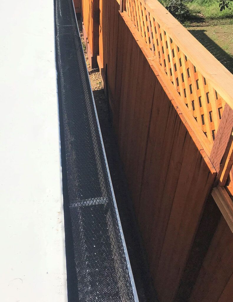 A close up of a wooden fence with holes in it