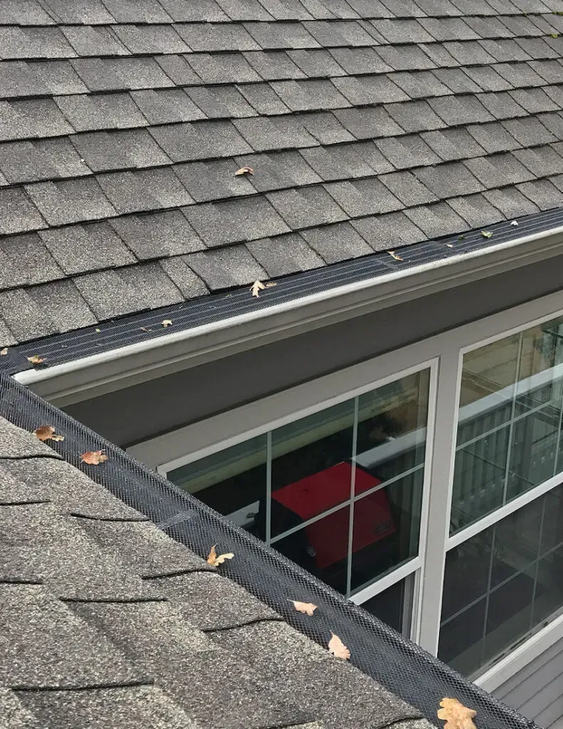 A roof with a gutter and a window on it.