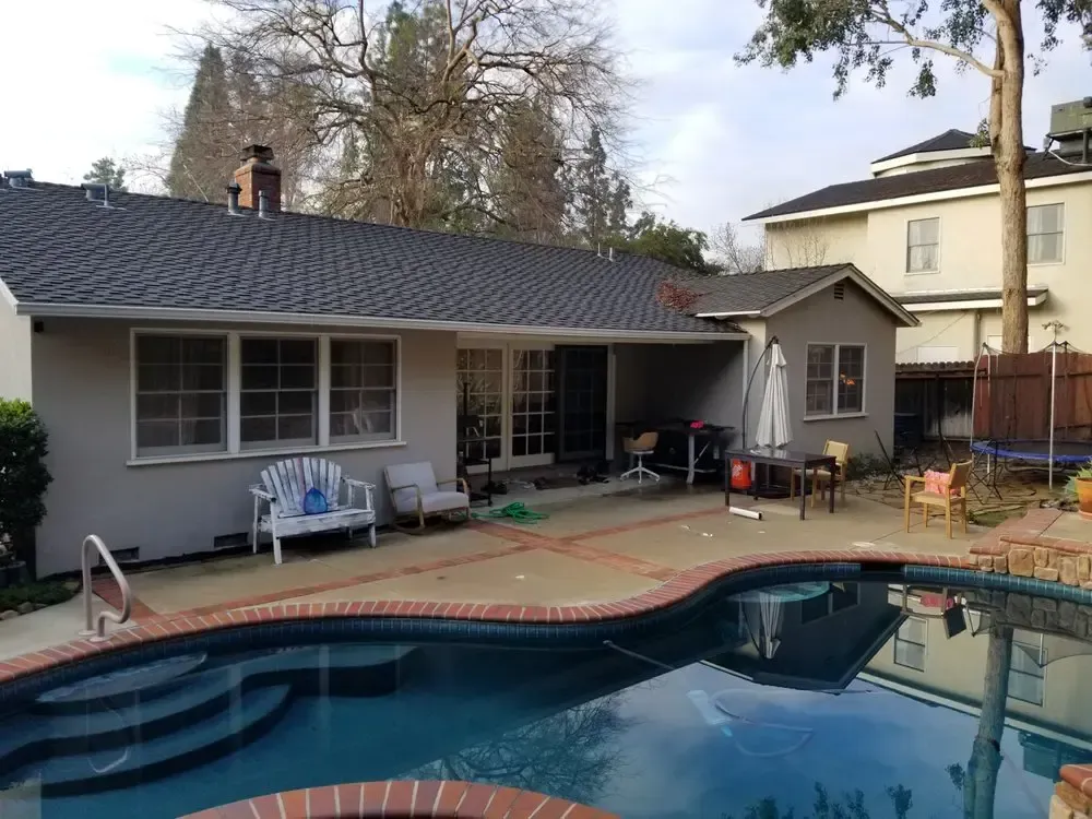 A house with a swimming pool in front of it