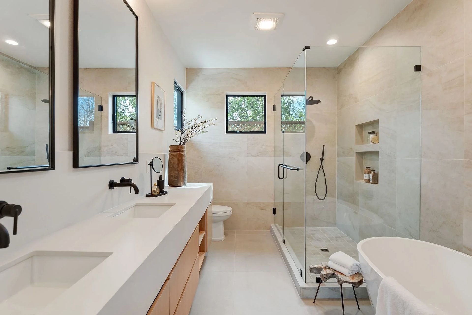 Modern bathroom with double vanity, walk-in shower, and freestanding tub.