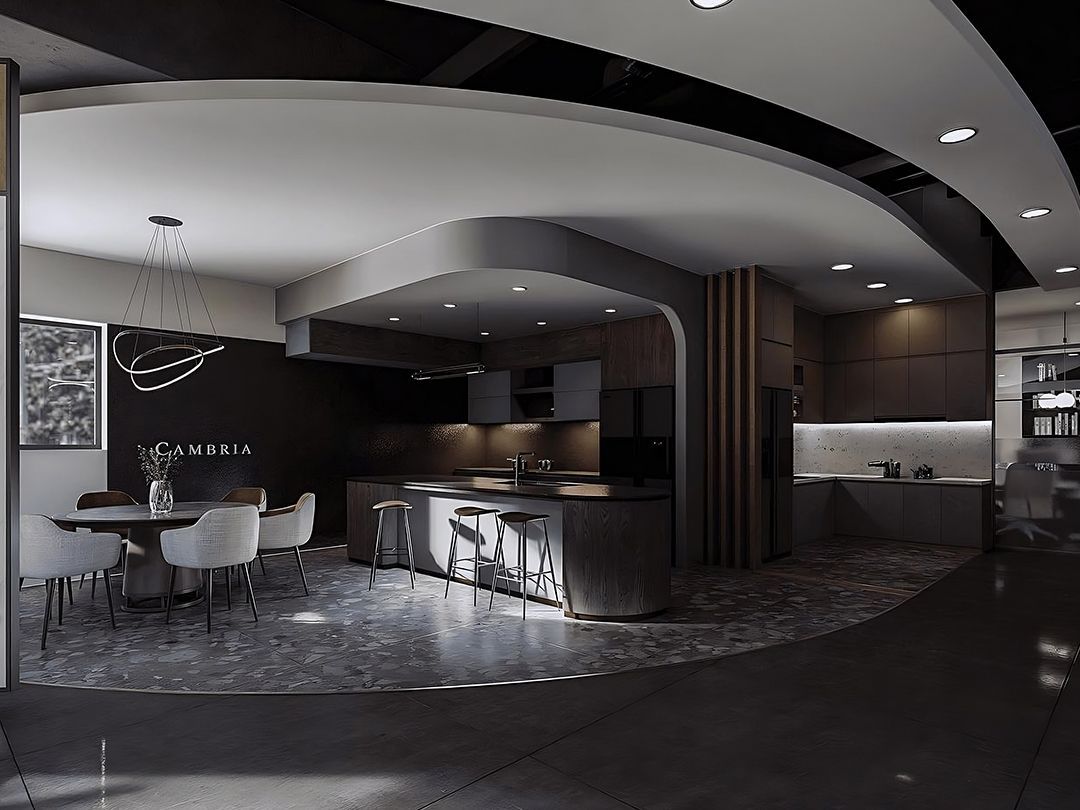 Modern kitchen and dining area with gray tones and curved architecture.