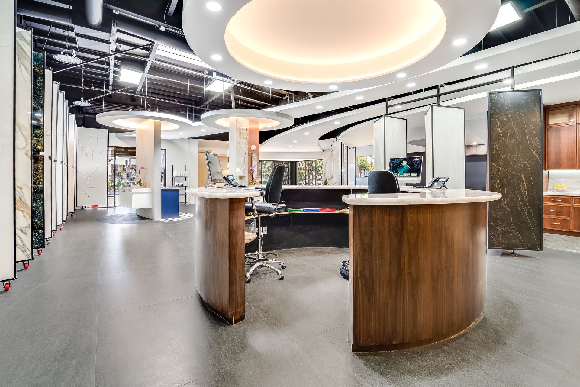 Modern showroom with curved wood counters and samples.