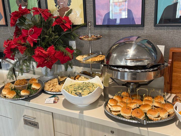 A table topped with plates of food and a buffet.