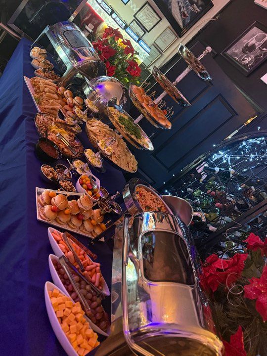 A buffet table with a lot of food on it.