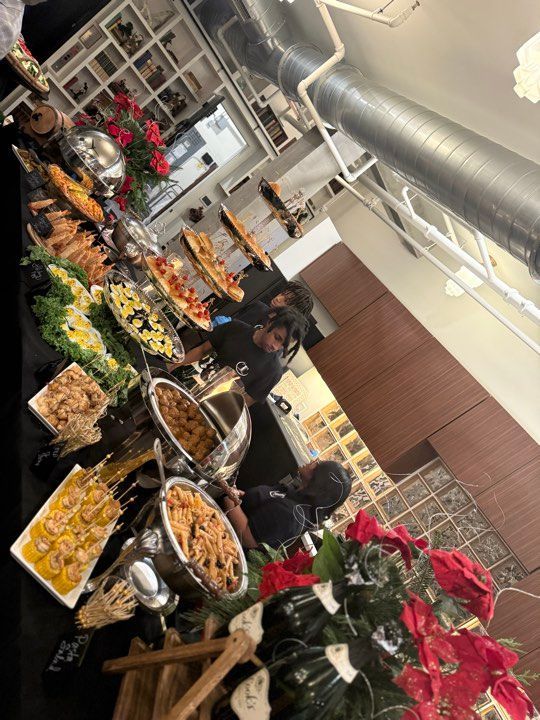 A buffet table with a lot of food on it in a kitchen.