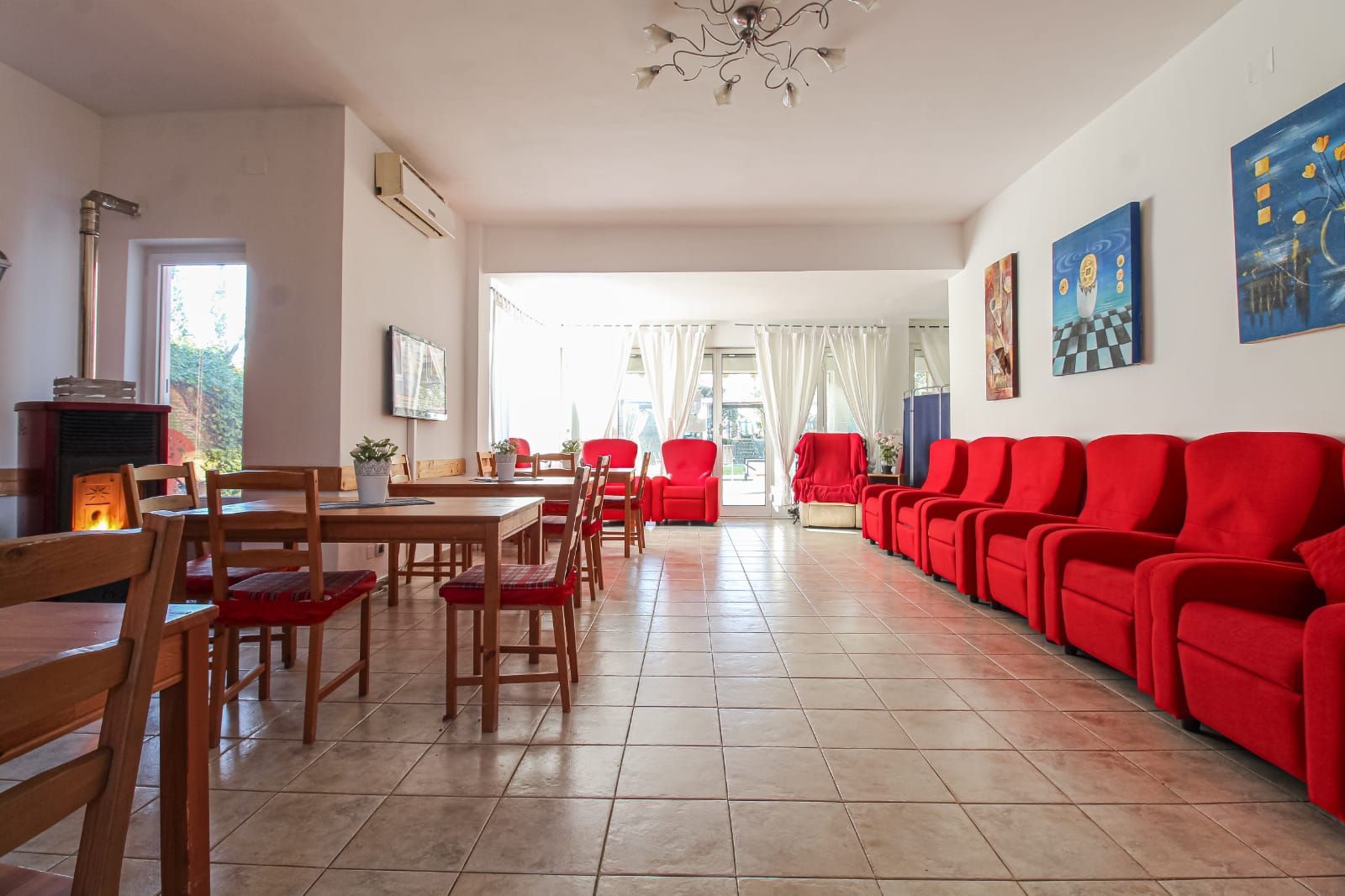 A large room with red chairs and tables
