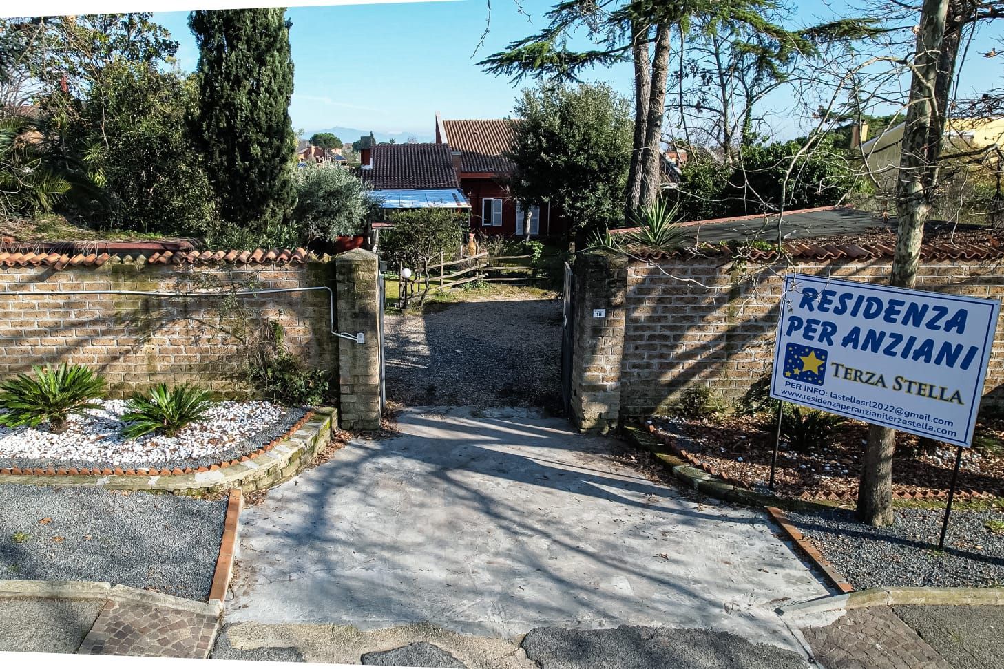 There is a sign that says residence per anziani on the side of the road.