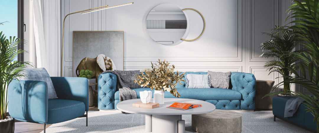 Living room with blue tufted sofa, armchair, round coffee table, plants, and gold accents.