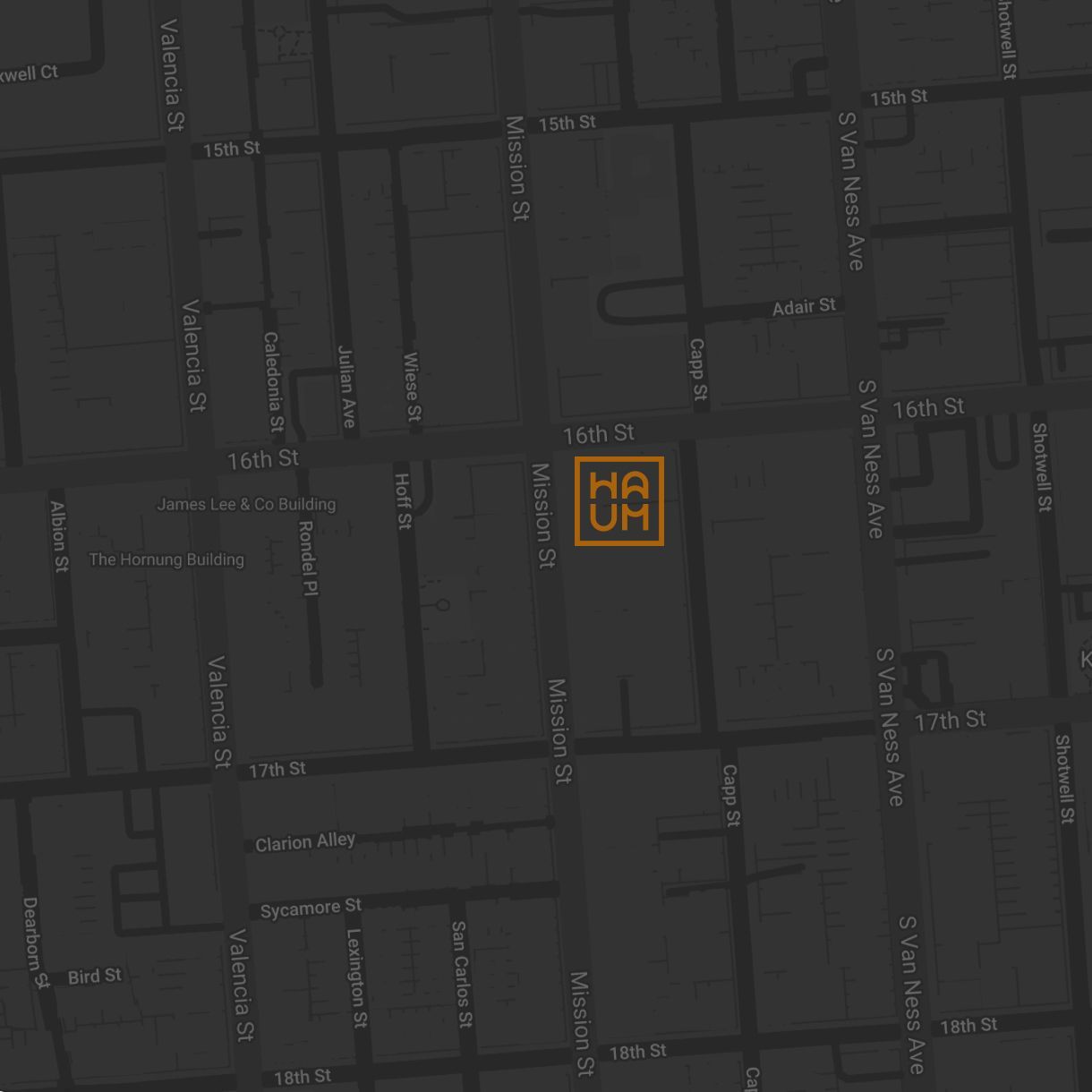 Dark street map with a highlighted orange square marker in the center
