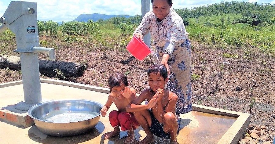 family enjoying clean water in Cambodia