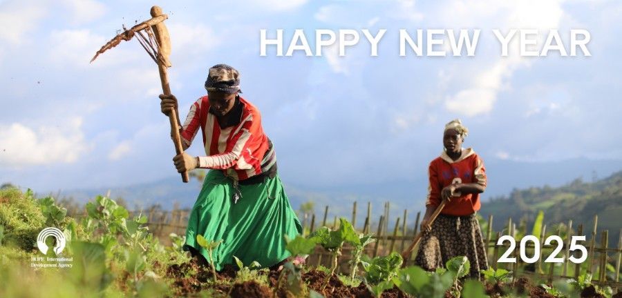 A man and a woman are working in a field.