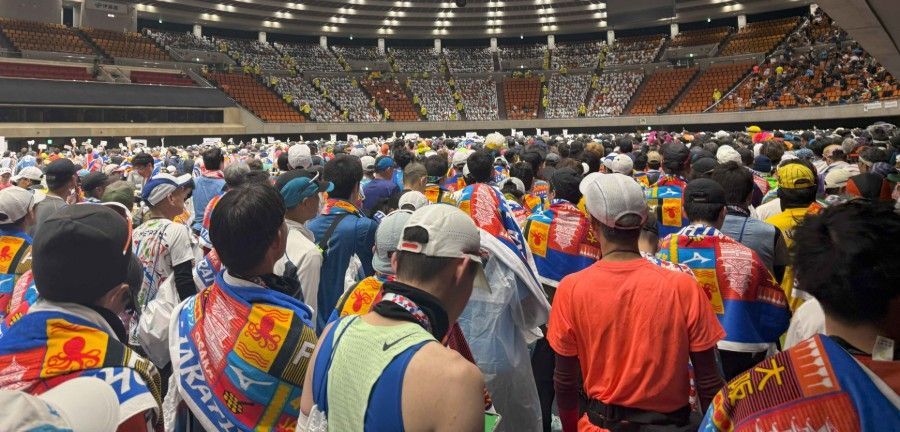 A large group of people are standing in a stadium.
