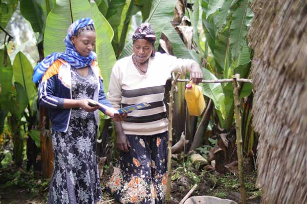 Women in Ethiopia using a tippy tap