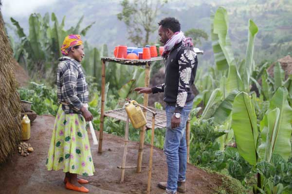 Couple in Ethiopia using a tippy tap