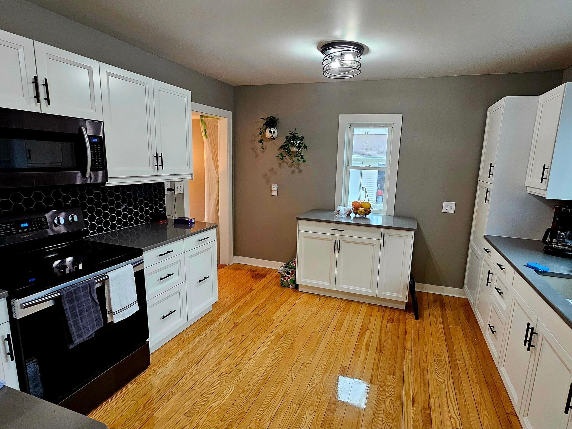 A kitchen with hardwood floors