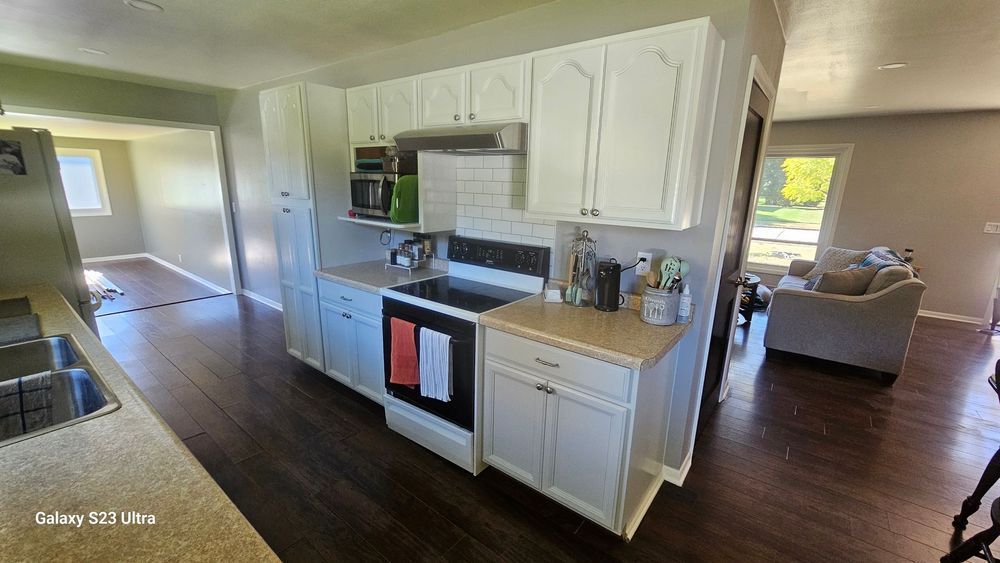 A kitchen with white cabinets