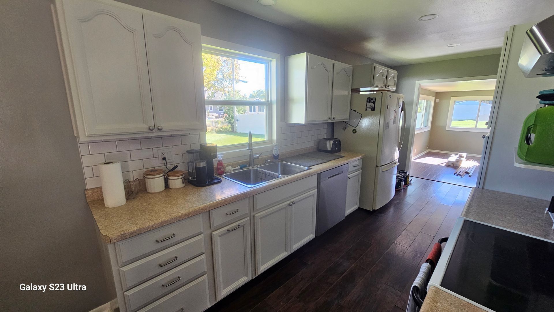 A kitchen with white cabinets