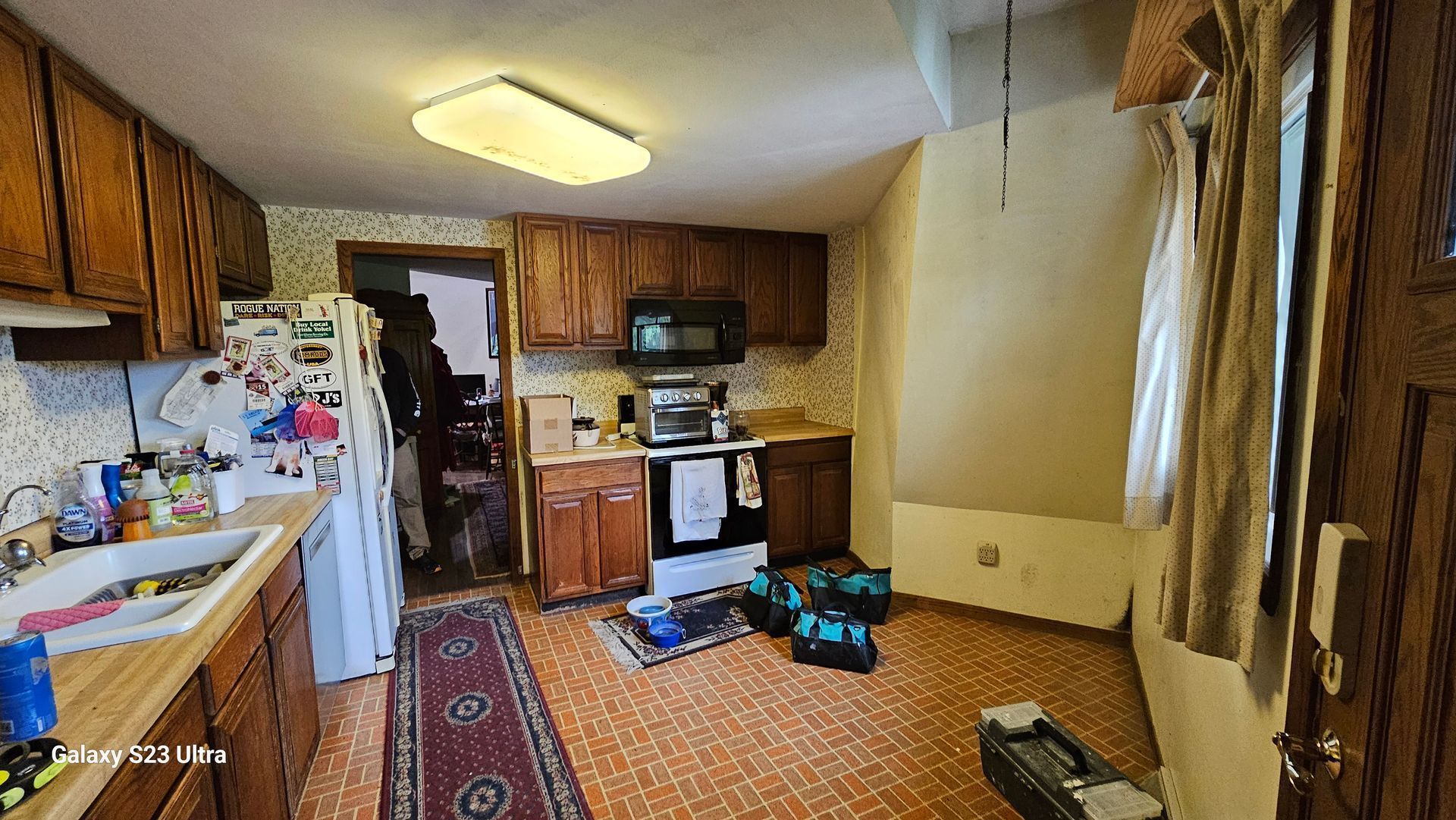 A kitchen with wooden cabinets