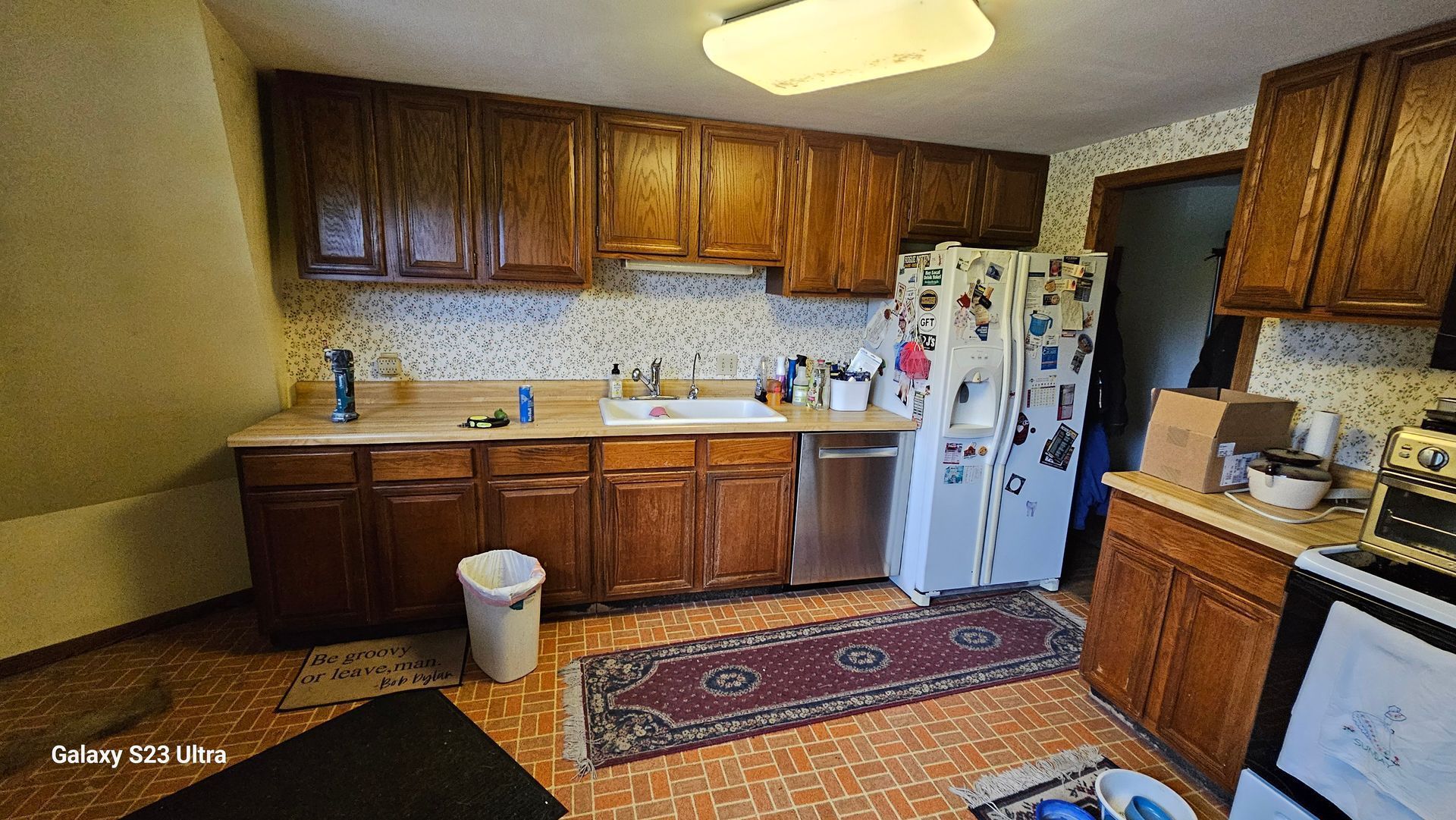 A kitchen with wooden cabinets and a white refrigerator