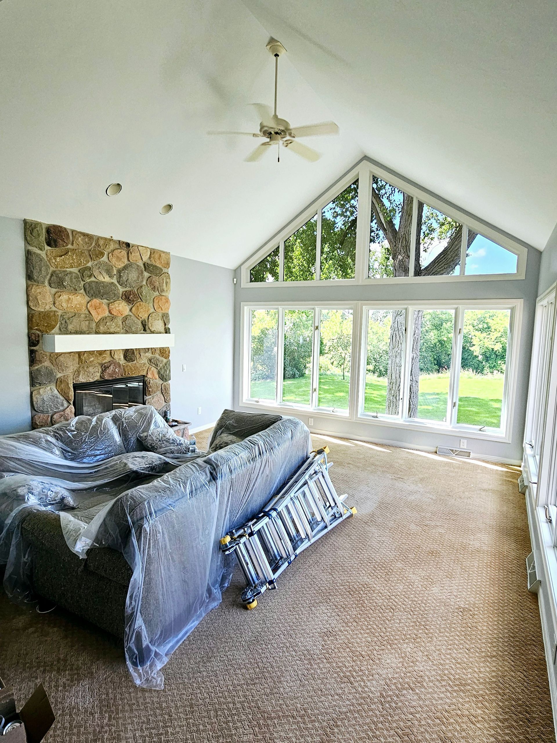 A living room with a couch and a ceiling fan