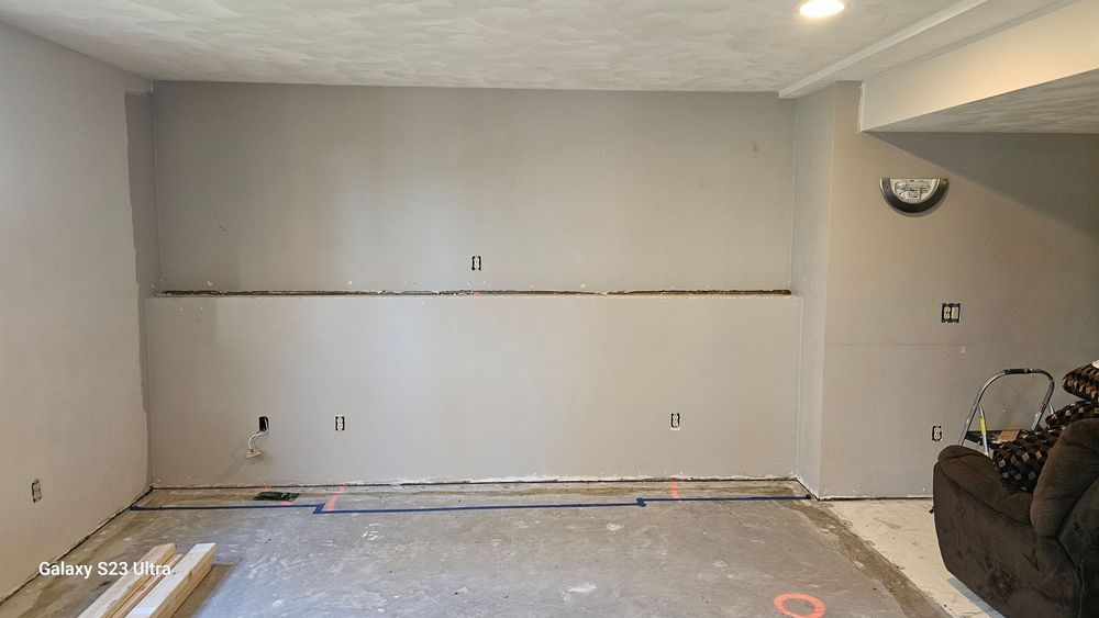 A room with a couch and a clock on the wall