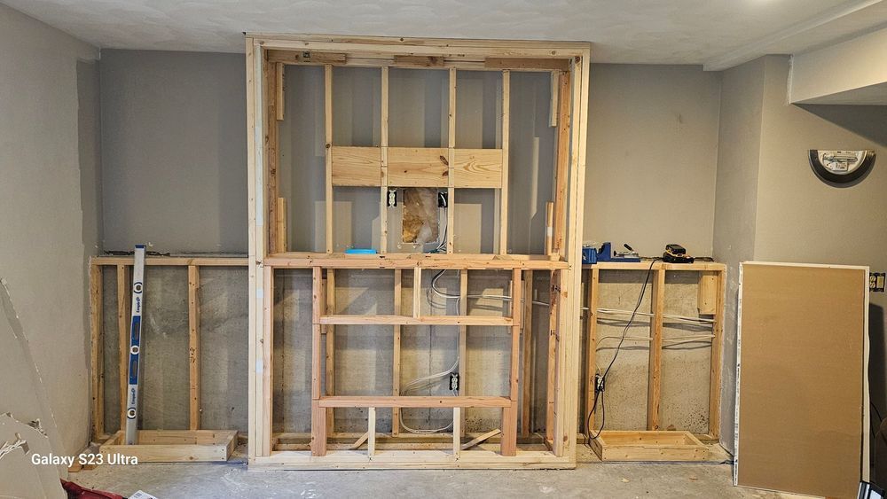 A room with a lot of wooden frames on the wall