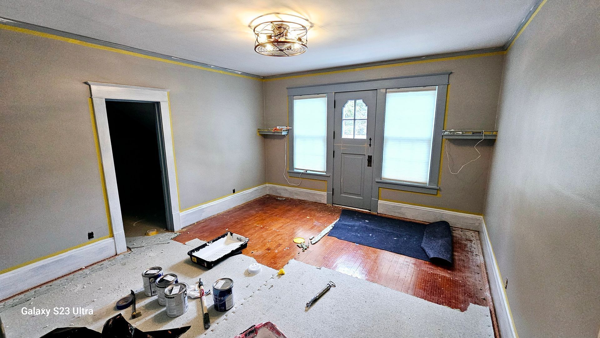 A living room is being painted in a house