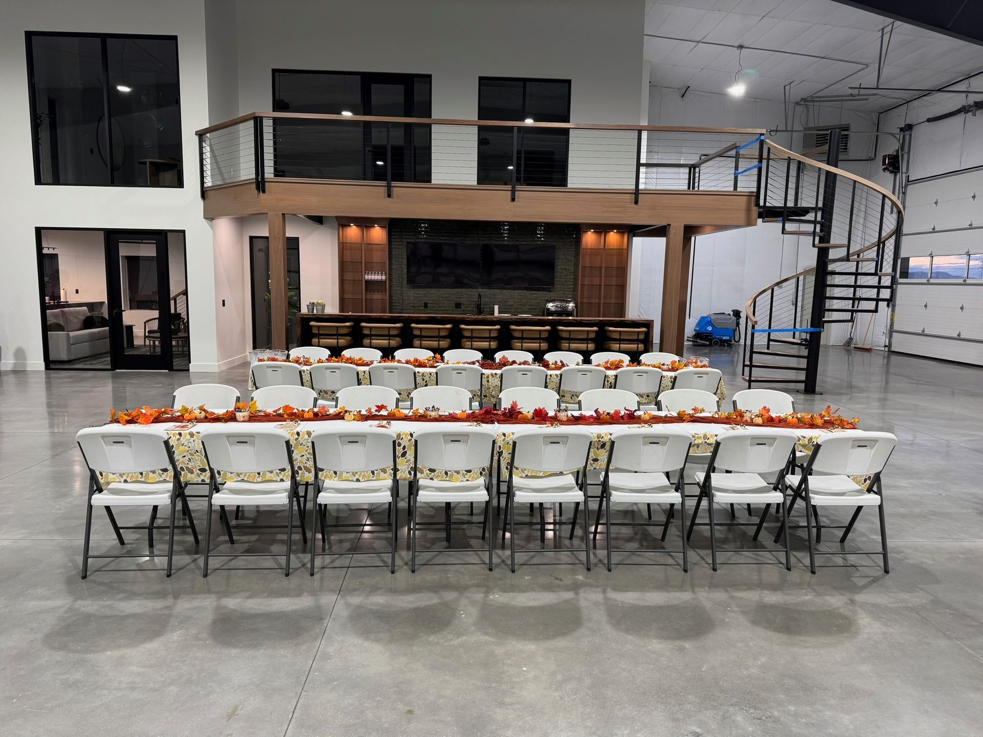 Chair rentals arranged inside an airport hangar for an event
