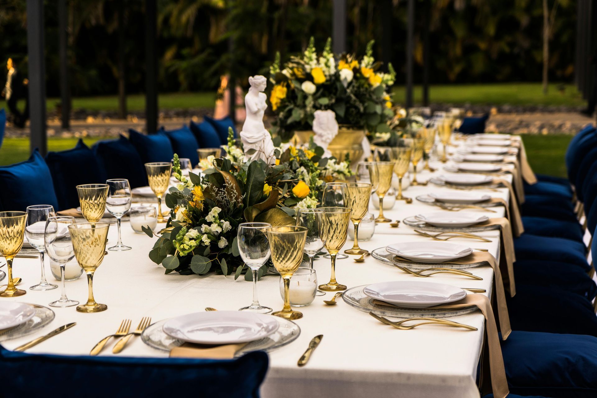 Outdoor event table setup with long rental tables for a formal gathering
