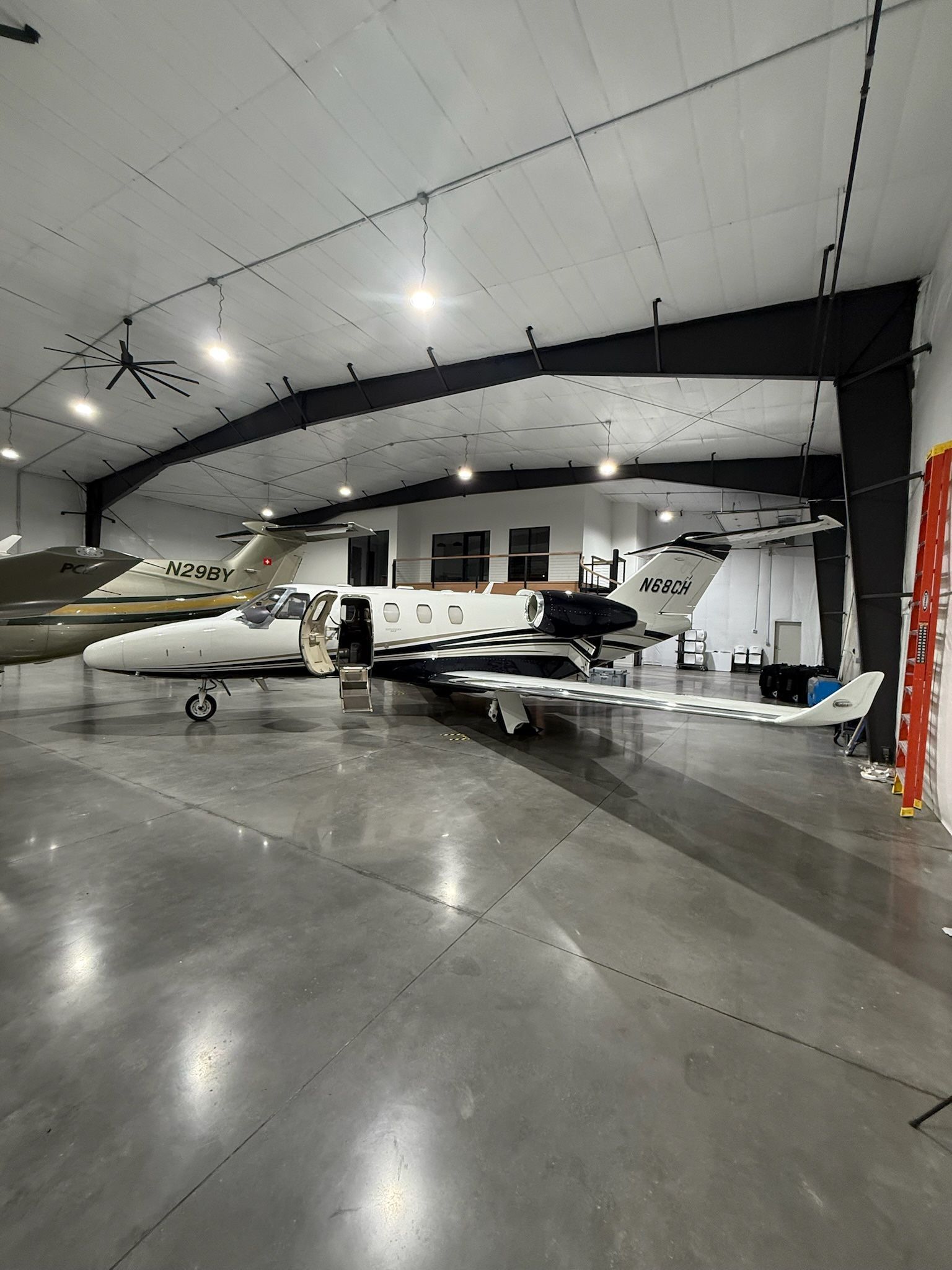 Large indoor venue setup using rental tables and chairs for events