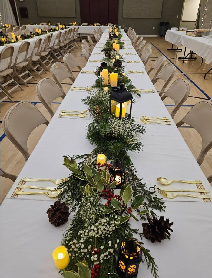 Long indoor table and chair rental setup for a formal event