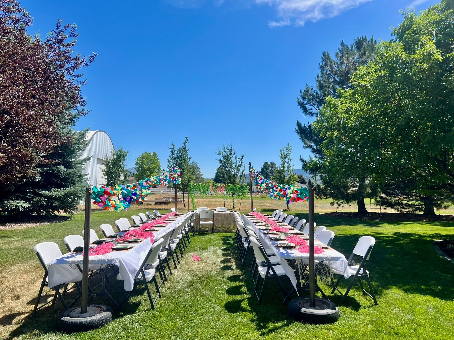 Backyard event setup with rental tables and chairs for a celebration